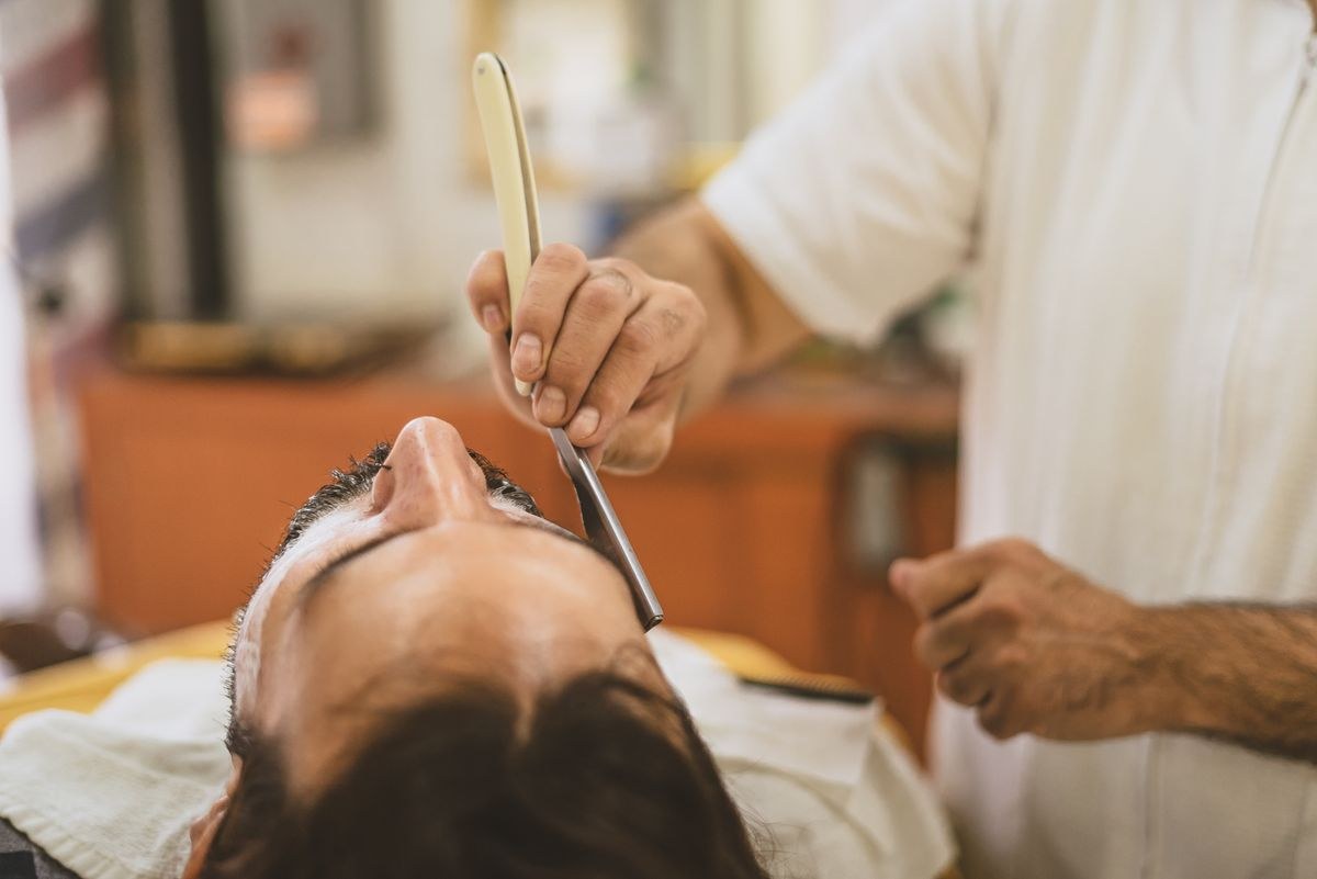 Straight razor shave in progress